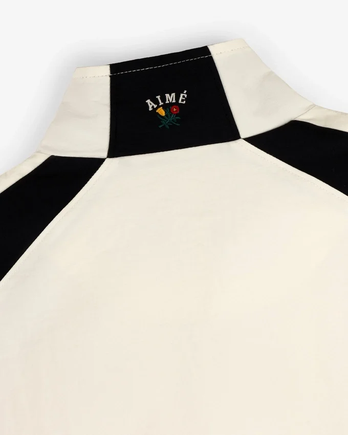 Pull en nylon à demi-zip avec écusson